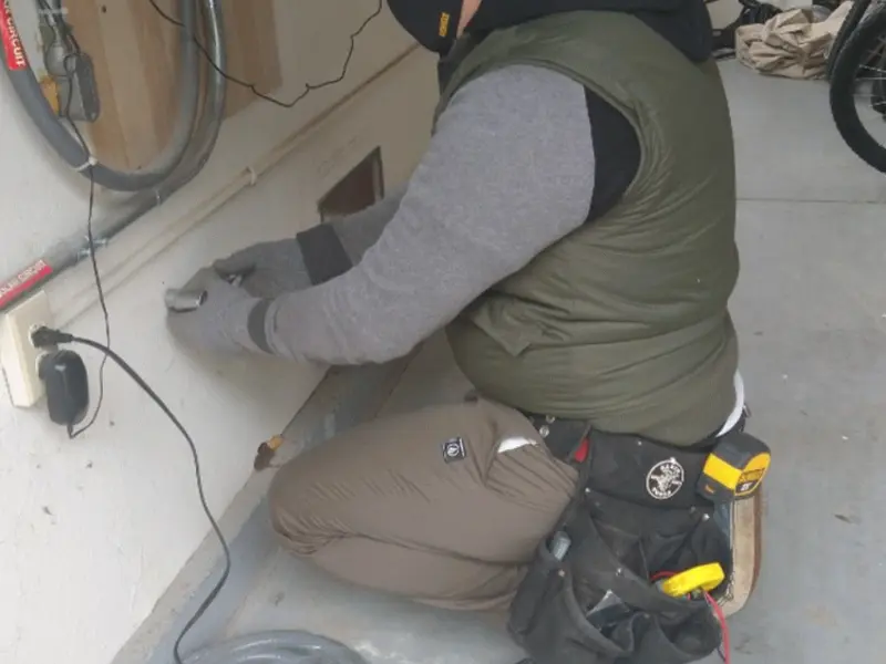 Electrician performing outlet wiring in a Hillsboro garage